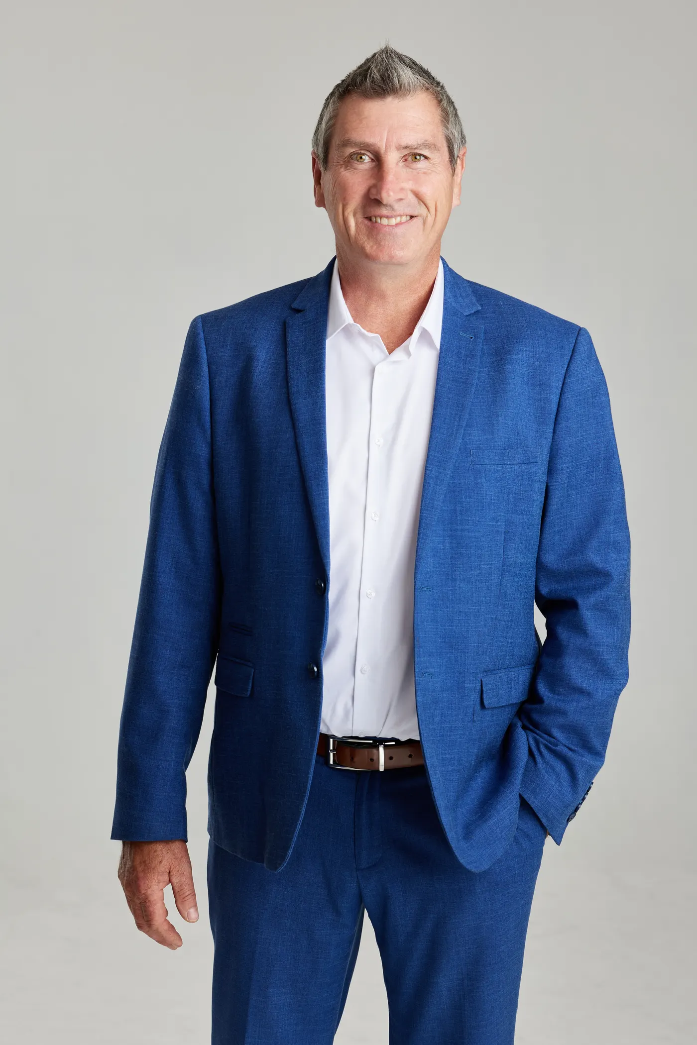 Brian McAllister, licensed real estate agent, in a blue suit