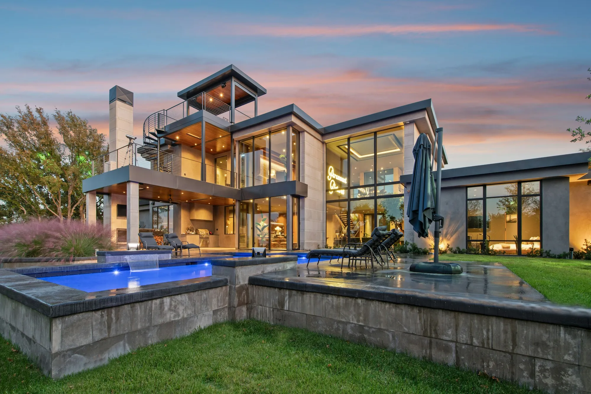 Luxury Perth home and swimming pool at dusk with glowing interiors